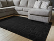 Gibbswell Black Washable 5' x 7' Area Rug laid flat in room