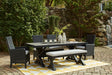 Beachcroft outdoor dining table with black frame and light gray top, front angle