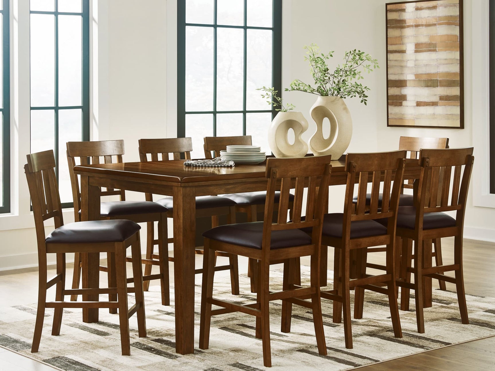 Ralene medium brown counter height dining table with eight faux leather barstools front view