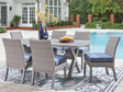 Half Gray Moon Beach outdoor dining table with 6 chairs, angled view