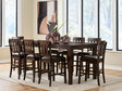 Haddigan dark brown counter height dining table with 8 matching barstools