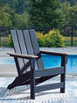 East Beach Adirondack Chair angled side view showing navy blue seat and driftwood arms