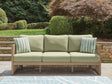 Serena Shores beige and green outdoor sofa with cushions front view