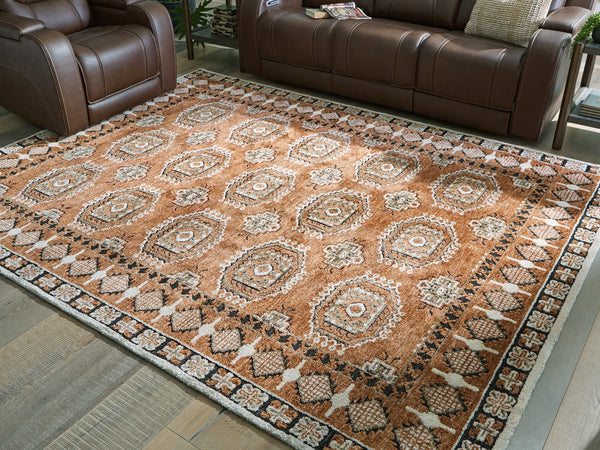 Qaabiz 7'8" x 10' area rug in sienna, ivory, and black medallion pattern