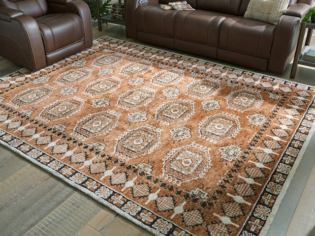 Qaabiz 7'8" x 10' area rug in sienna, ivory, and black medallion pattern