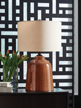 Aaleahya rust finish table lamp showing distressed glass base and fabric shade
