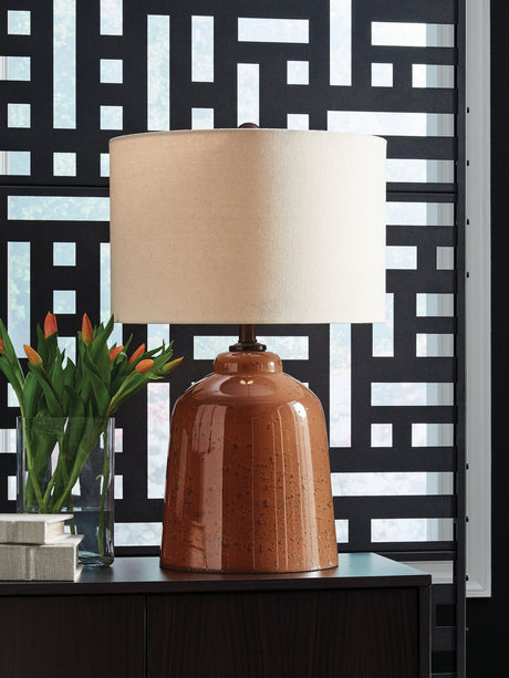 Aaleahya rust finish table lamp showing distressed glass base and fabric shade