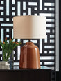 Aaleahya rust finish table lamp showing distressed glass base and fabric shade