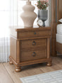 Rowlenstown brown wood nightstand angled view
