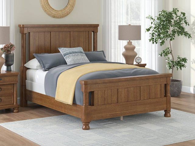 Rowlenstown Brown Queen Poster Bed, front view showing poster headboard and footboard
