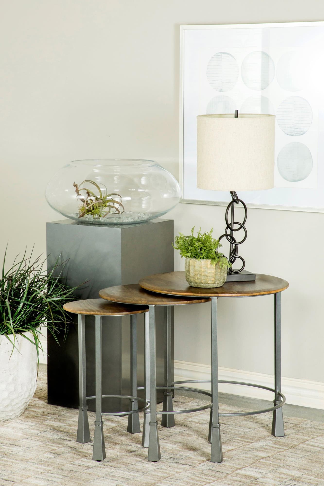 Deja 3-piece round nesting tables with mango wood tops and gunmetal iron legs, angled front view