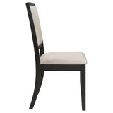Side view of Louise Dining Chairs with black legs and cream cushions