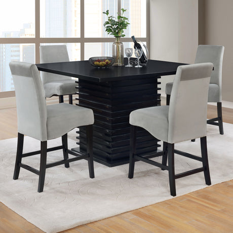 Detail of Stanton dining set black table and gray upholstered chairs