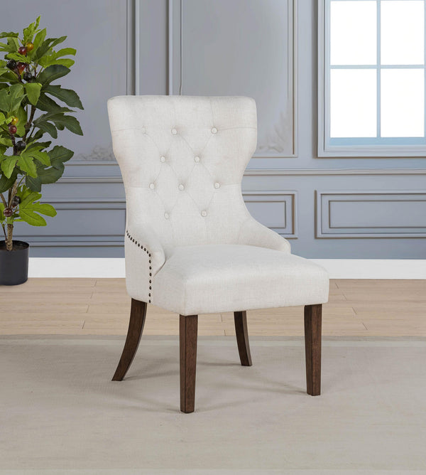 Side angle of Baney cream fabric upholstered wingback dining chair