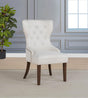 Side angle of Baney cream fabric upholstered wingback dining chair