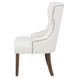 Detail of nailhead trim on Baney cream fabric chair arm