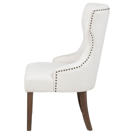 Detail of nailhead trim on Baney cream fabric chair arm