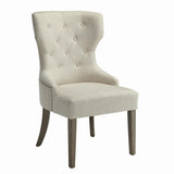 Close-up of beige tufted back with nailhead trim