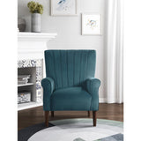 Urielle teal velvet accent chair positioned in a room setting