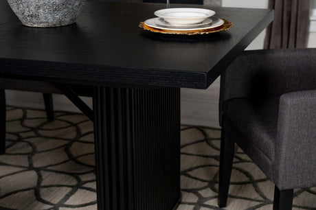 Black wood dining table in styled dining room setting