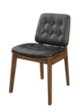 Side angle of Otterson tufted back side chair showing tufted back and curved armrests