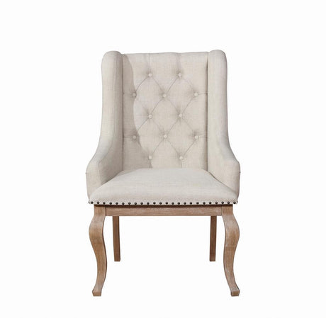 Close-up of diamond button tufting and nailhead trim on armchair back
