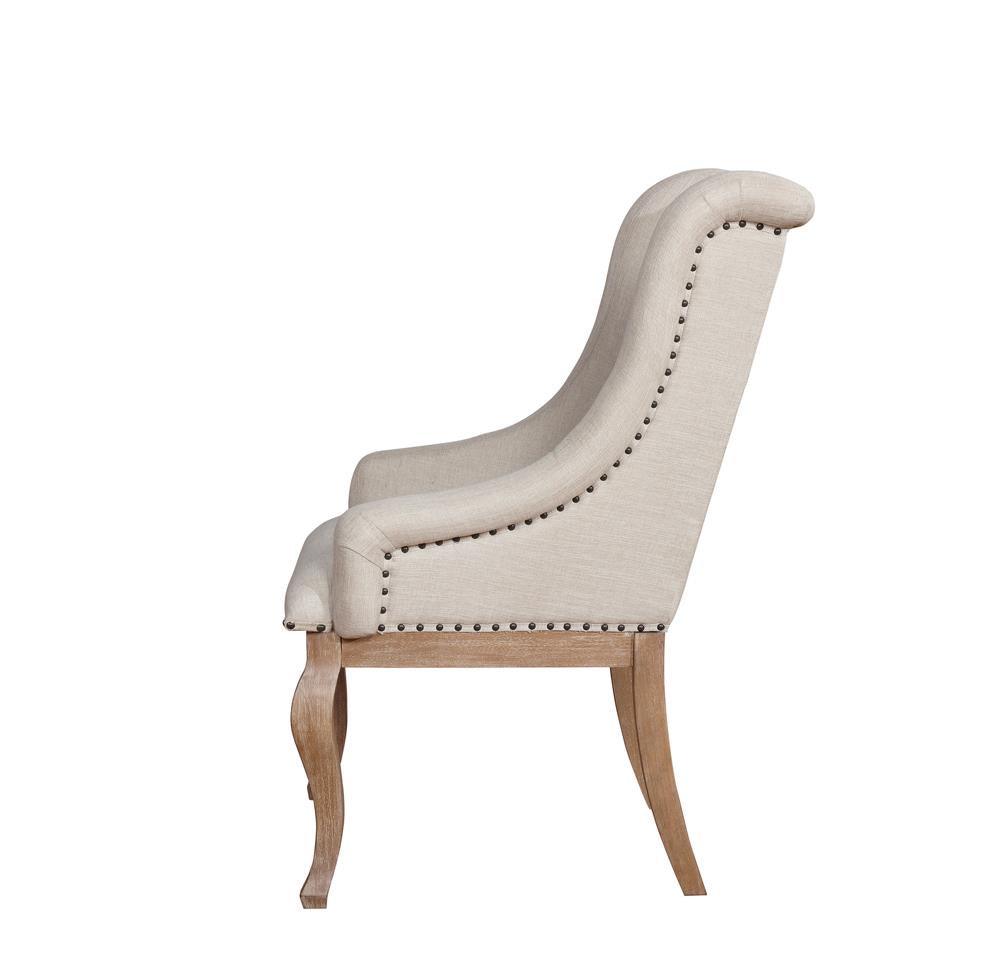 Detailed view of cushioned seat and wooden legs of Brockway Cove arm chair