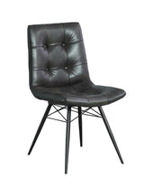 Close-up of charcoal grey button tufted PU leather chair seat