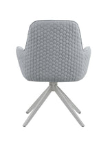 Detail of chrome swivel base and metal legs of Abby Dining Chair