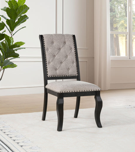 Side angle of Phelps upholstered dining chair showing distressed noir rubberwood legs