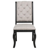 Close-up of tufted chair back with bronze nailhead detail
