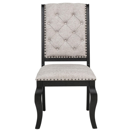 Close-up of tufted chair back with bronze nailhead detail