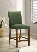Paxton green upholstered dining chair with rubberwood frame detail