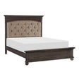 Side angle view of Motsinger king bed showing nailhead trim and bun feet