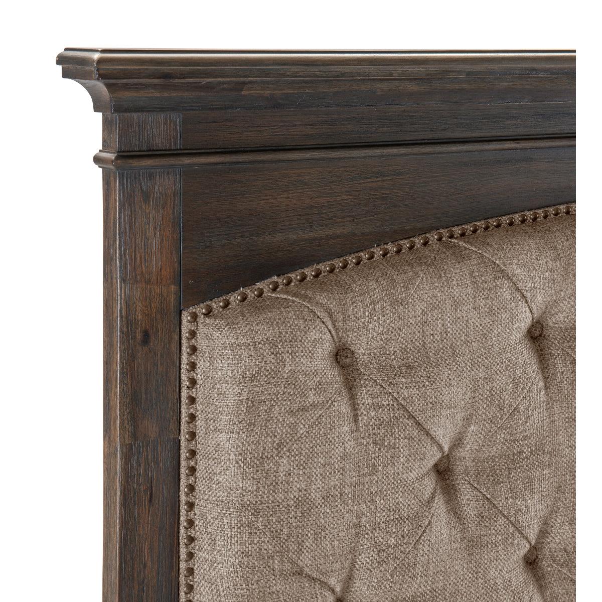 Close-up of nailhead trim detail on the tufted headboard