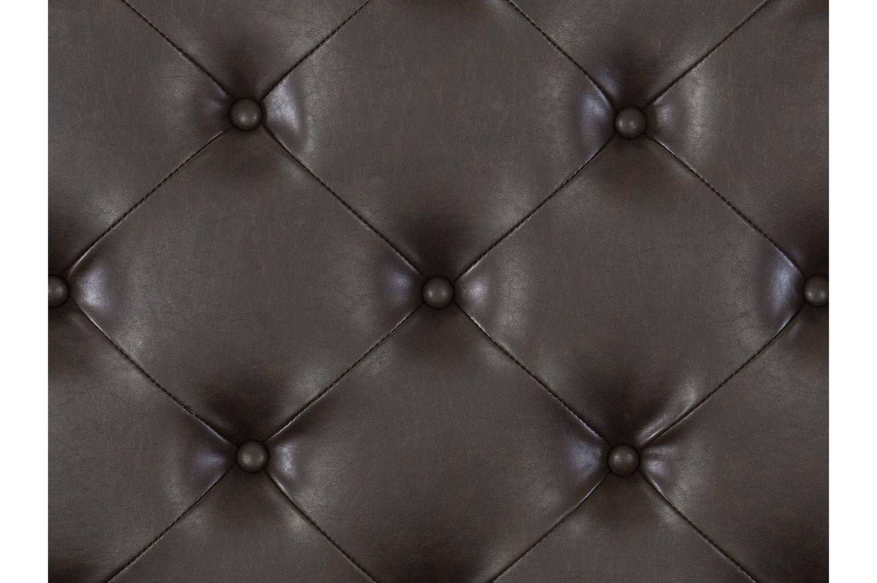 Bedroom view focusing on faux leather upholstery and tufting