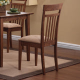 Room setting featuring chestnut rectangular dining table and tan cushioned mission chairs