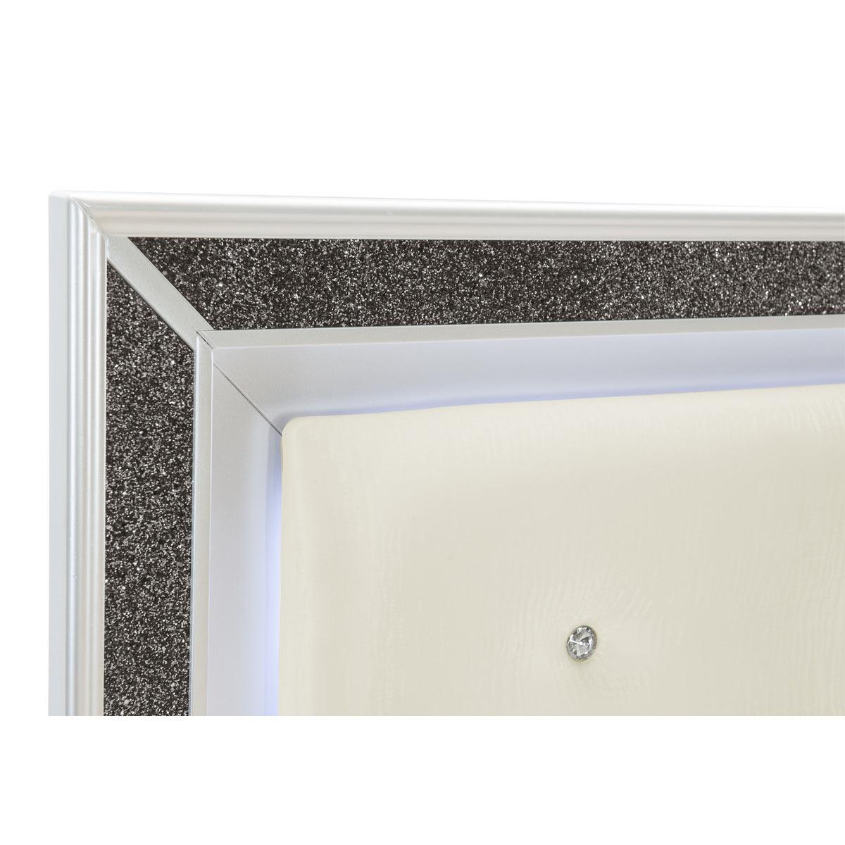Detail of silver glitter trim on pearl white wood bed frame
