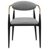 Closeup of the black powder-coated metal frame and gold armrests