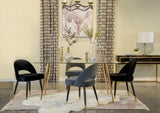 Modern dining table with glass top and black metal frame, view from side