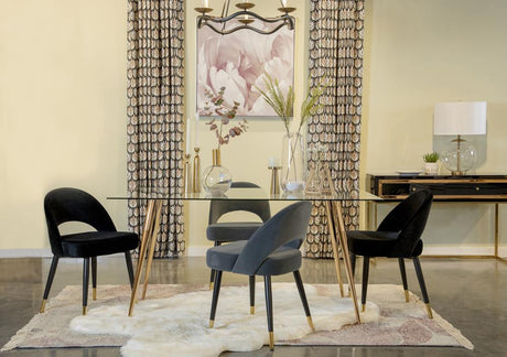Modern dining table with glass top and black metal frame, view from side