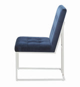 Close-up of button-tufted blue upholstery on Cisco dining chair