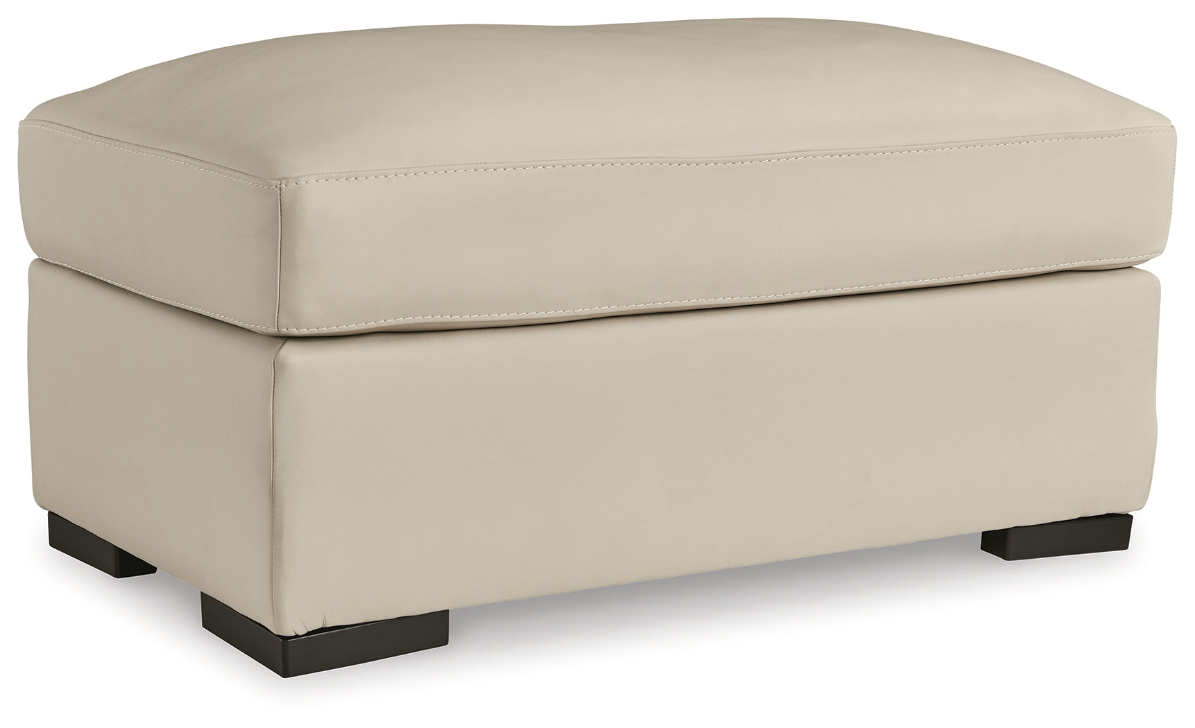 Treasure Trove Ottoman front view in almond upholstery