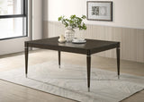 Metal-capped tapered leg and metallic accents detail on Reseda table