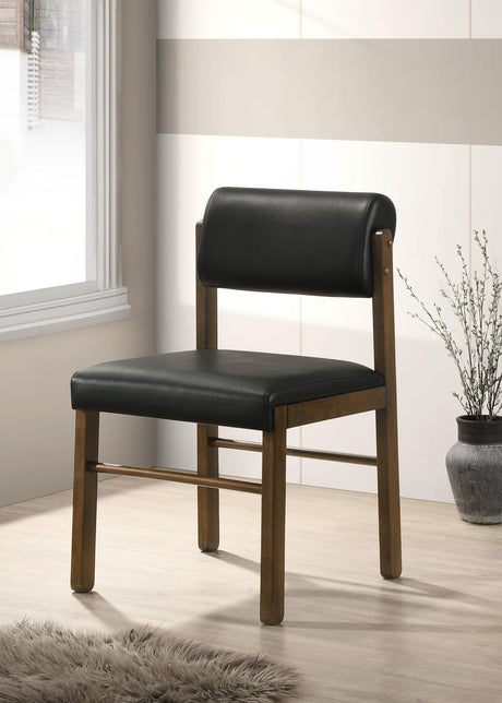 Side view of Kehoe black leatherette dining side chair showing curved backrest