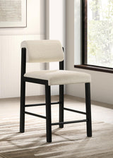 Side view of Kehoe cream upholstered counter height chair with footrest