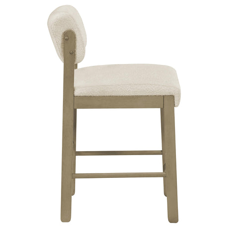 Rubberwood legs with footrest stretchers detail on Kehoe upholstered chair