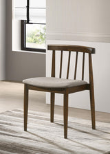Side angle of Cullen dining side chair showing curved spindle back and tapered legs