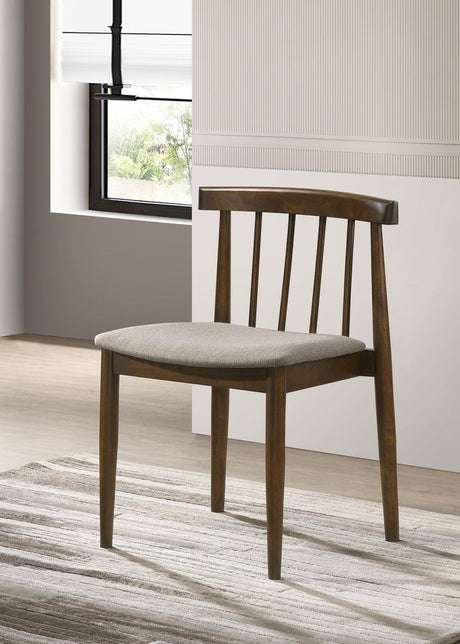 Side angle of Cullen dining side chair showing curved spindle back and tapered legs