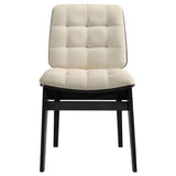 Side angle showing tapered black rubberwood legs and cream velvet seat